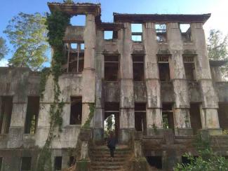 Girl in access stairs to an abandoned sanatorium